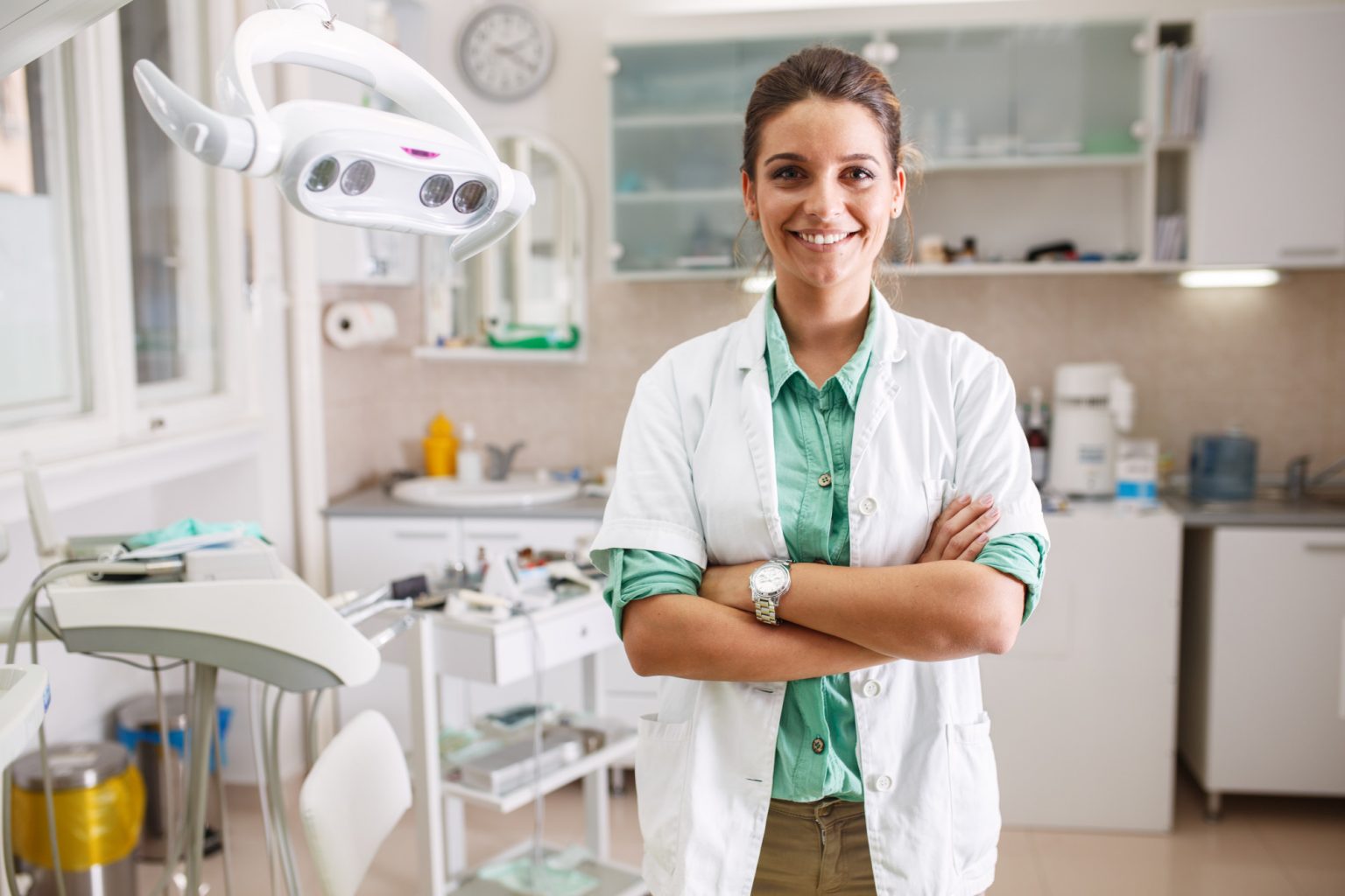 Portrait of female dentist .She standing in her dentist office.